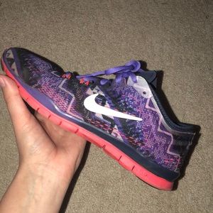 Purple and coral Nike Free Run tennis shoes